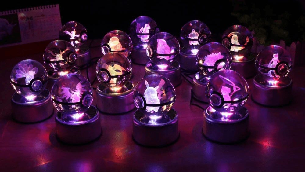 Set of crystal ball-like objects with glowing purple and blue lights on a dark surface.