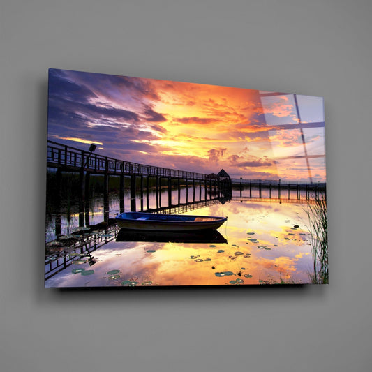 Rowboat by Pier Under Fiery Clouds Glass Wall Art