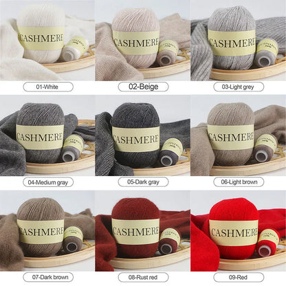 Collection of cashmere yarn balls in various colors with labels on a wooden tray.