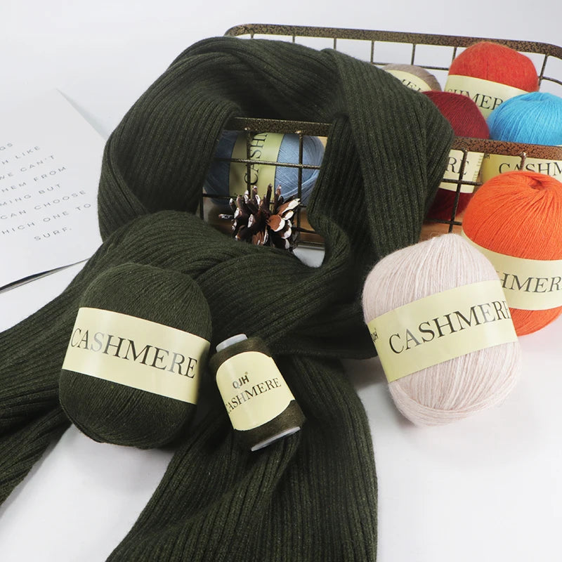 Green cashmere yarn skeins with labels on a white surface