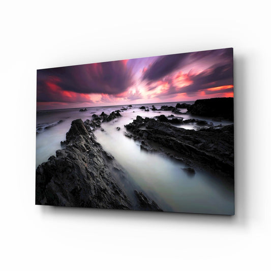 Crimson Sky Over Black Rocks Glass Wall Art
