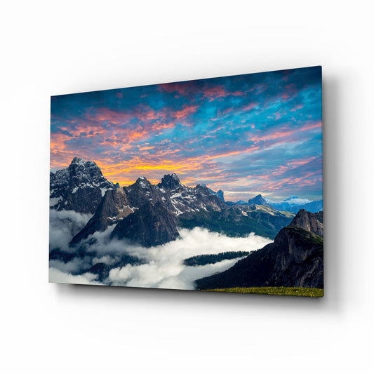 Fiery Sunset Clouds Over Rocky Peaks Glass Wall Art